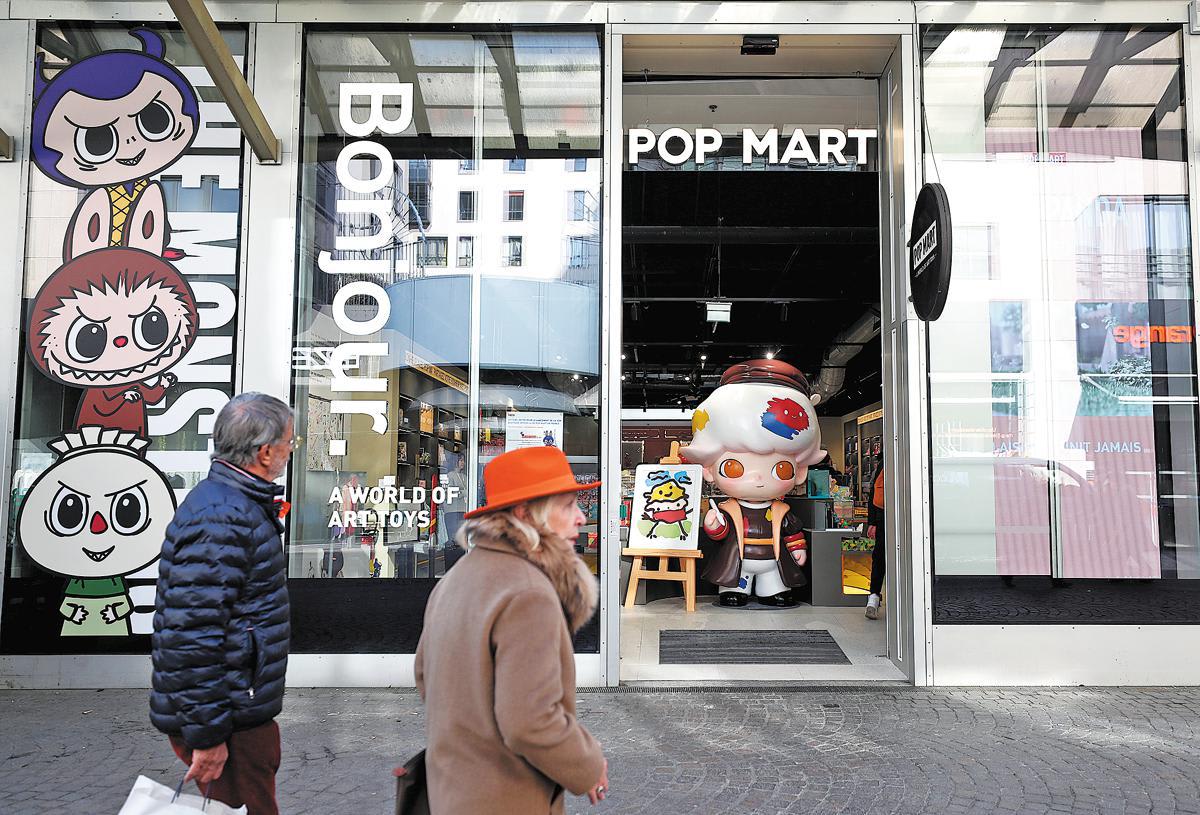 A Pop Mart retail store featuring large art toy characters on its windows, demonstrating the brand's international physical presence.