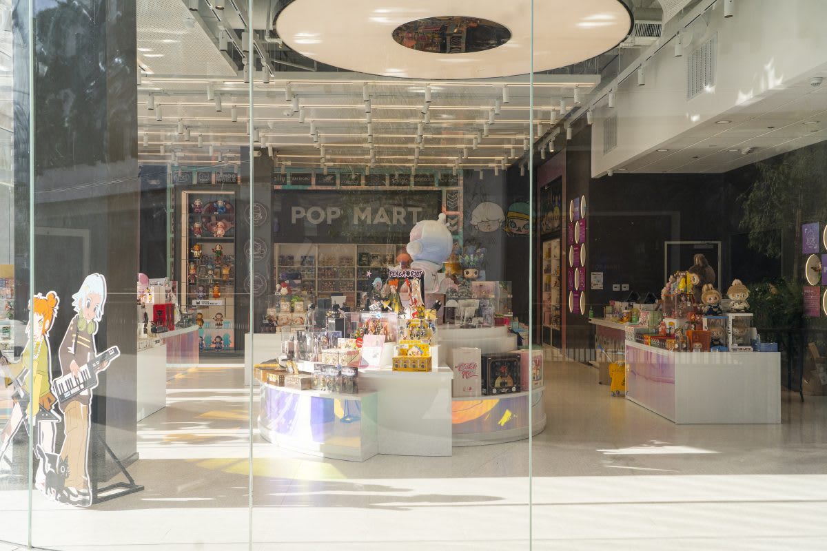 Inside a modern Pop Mart retail store, showcasing its vibrant collection of toys and figures.
